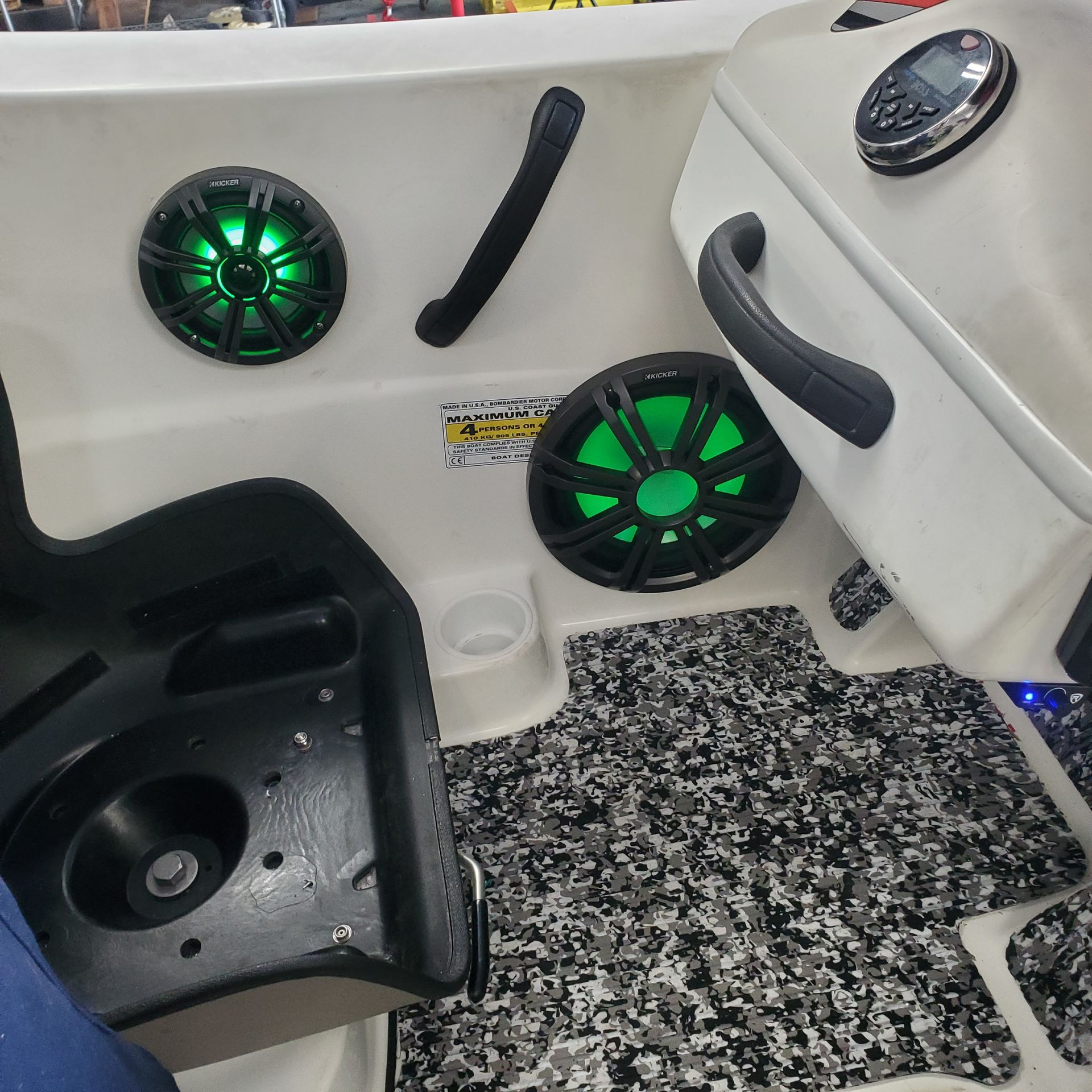 A boat with green speakers and a dashboard