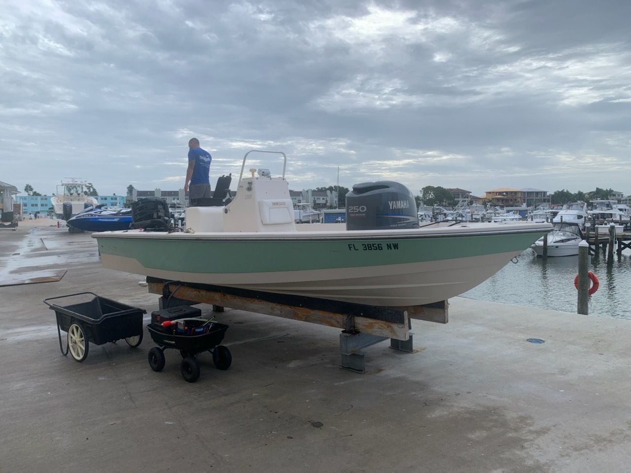 A boat is sitting on a dock next to a wheelbarrow.