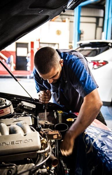 Mechanic Working on A Car Engine in A Garage — DK Mechanical Repairs in Warners Bay, NSW