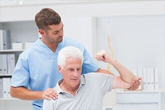 Giving physical therapy to man — Physical Therapist in Old Bridge, NJ
