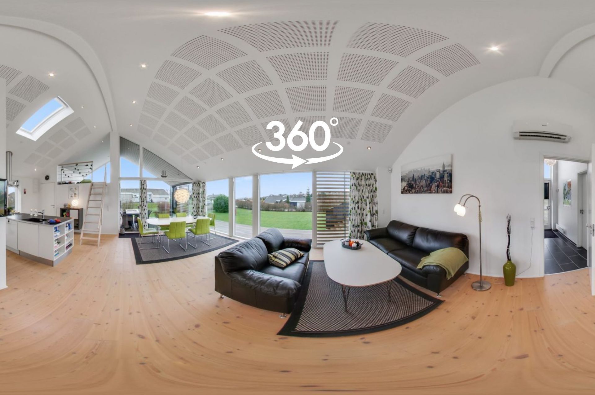 a 360 degree view of a living room with a couch and a table .

