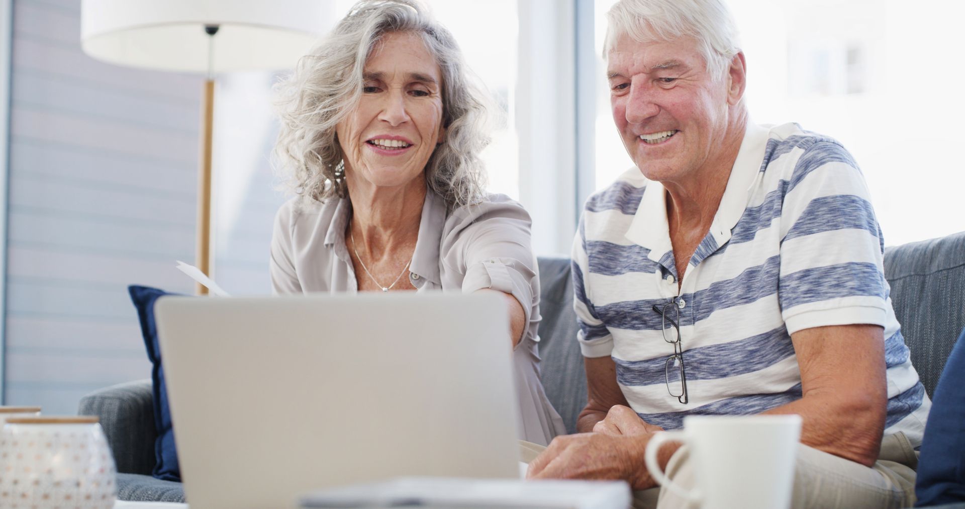 Smiling older couple looking at a laptop together