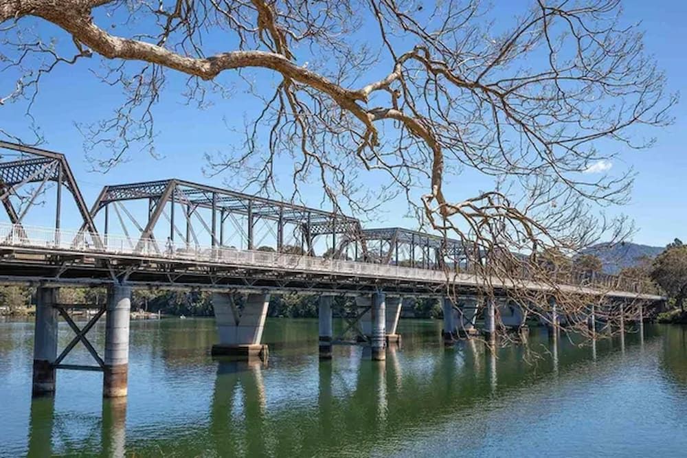 A Bridge Over A Body Of Water With Trees In The Background — Mike's Tree Services In Nowra, NSW