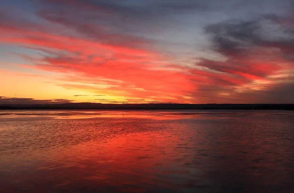 Sunset Over A Body Of Water With Red Clouds In The Sky — Mike's Tree Services In Sanctuary Point, NSW