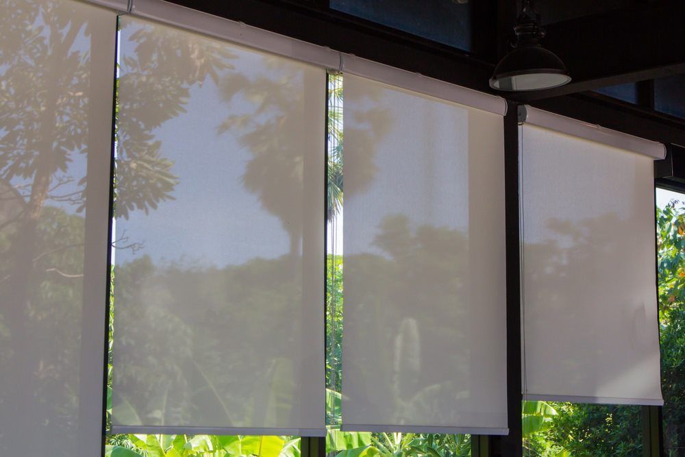 A Close Up of a Window With Roller Blinds on It — Design 2000 Blinds & Awnings In San Remo, NSW