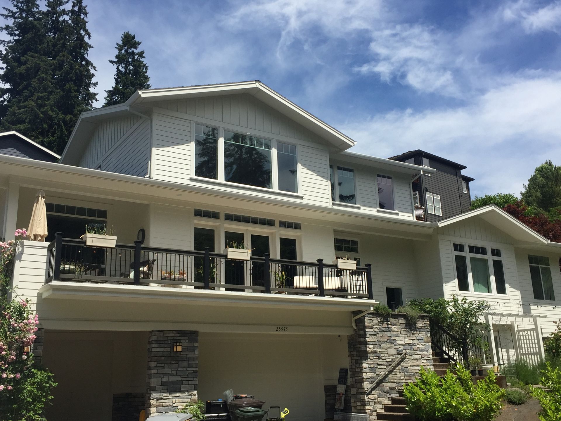 A large white house with a lot of windows and a balcony