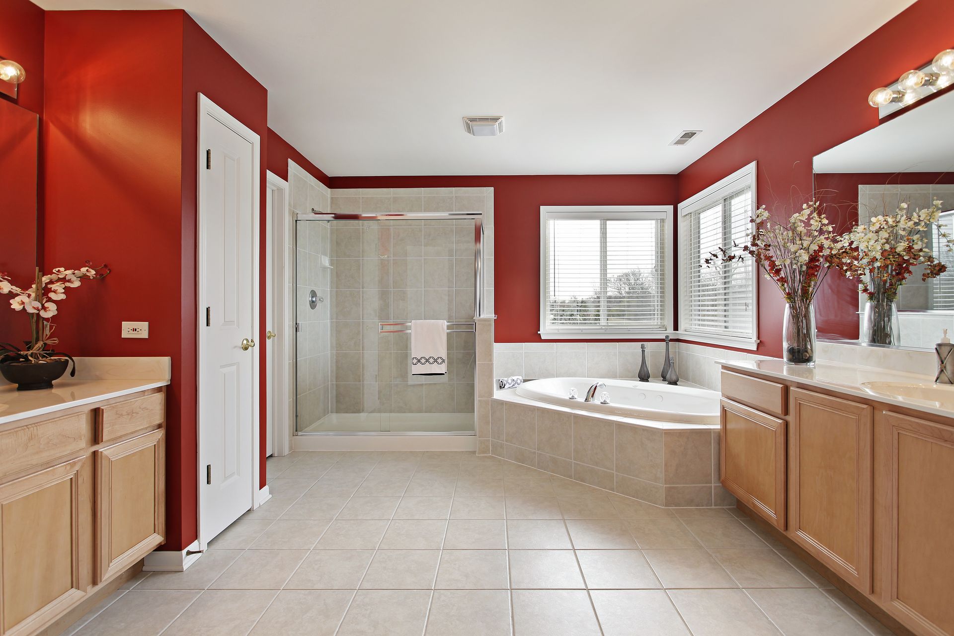 A bathroom with red walls and a bathtub