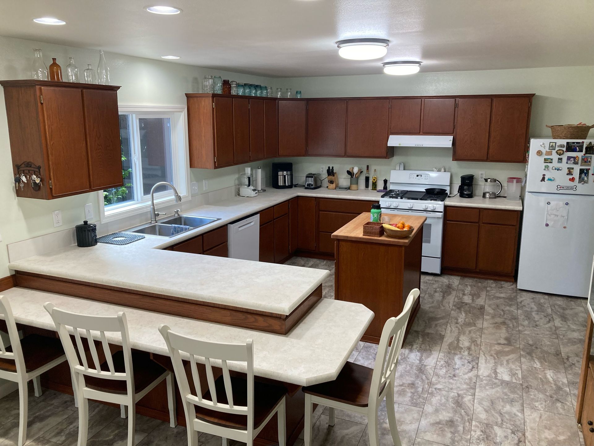 A kitchen with wooden cabinets and a white refrigerator