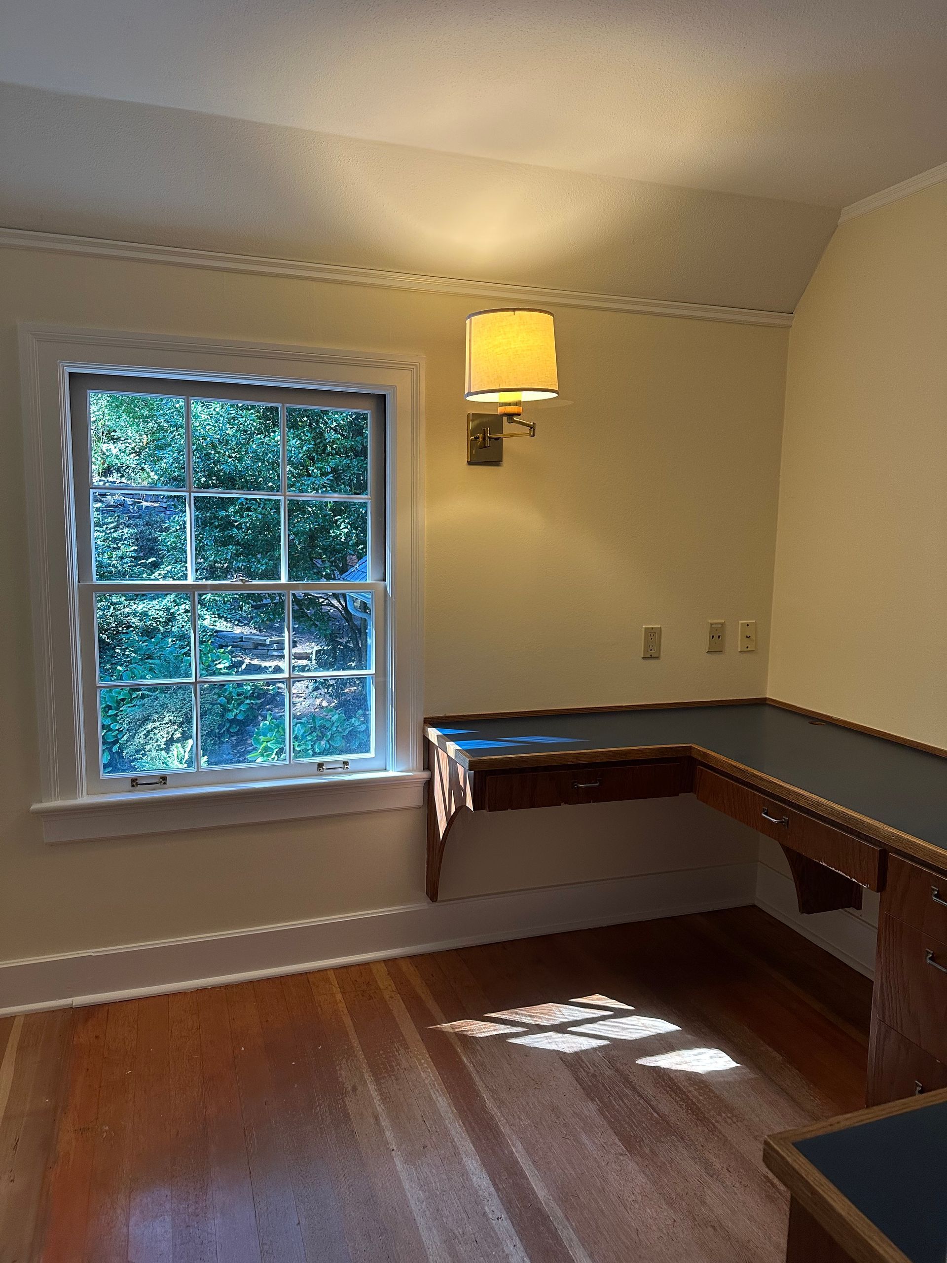 An empty room with a desk and a window
