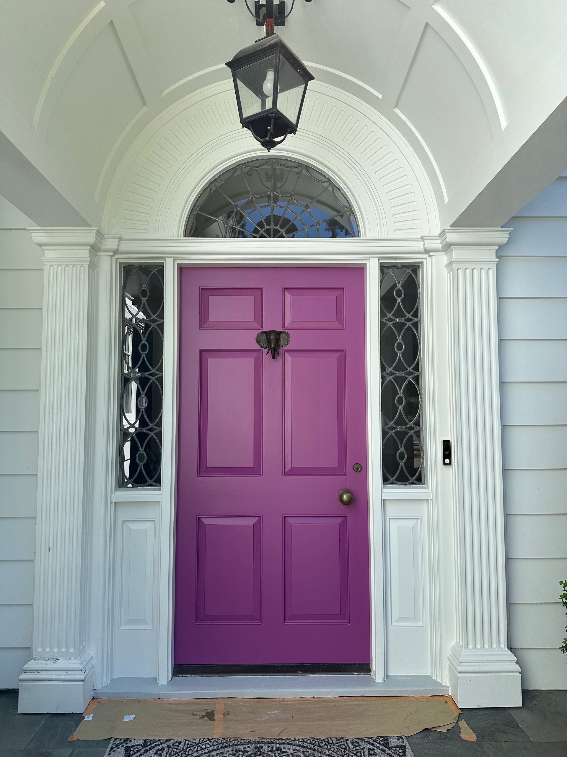 A white house with a purple door