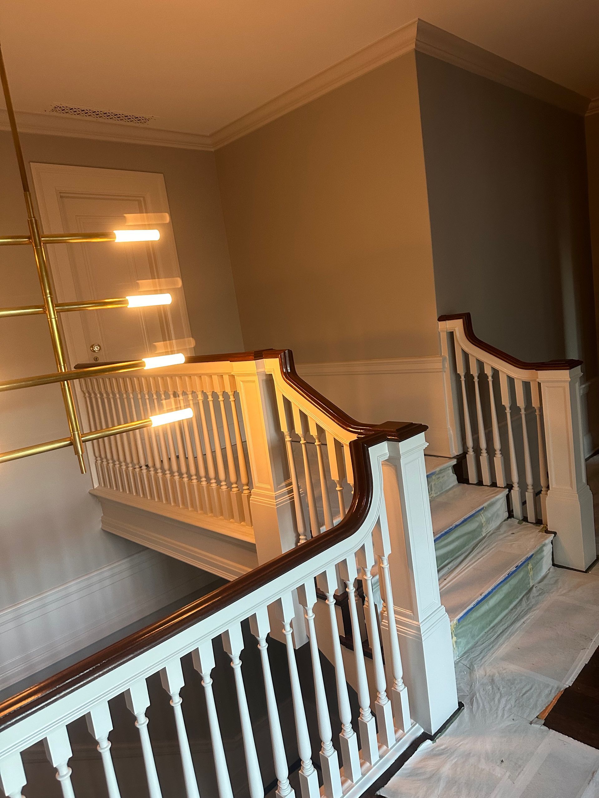 A staircase with a white railing and wooden steps in a house.
