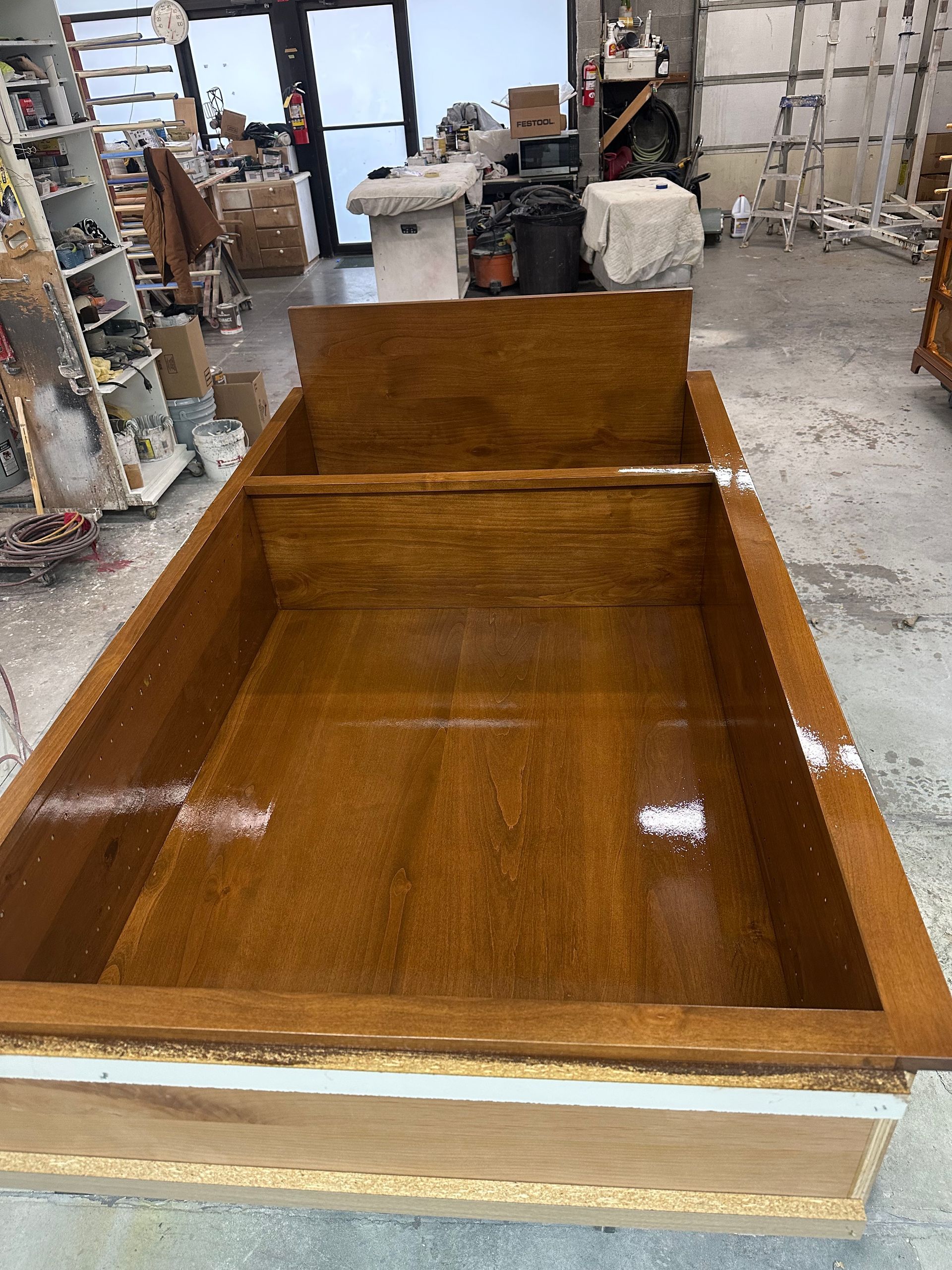 A large wooden bathtub is sitting in a room.