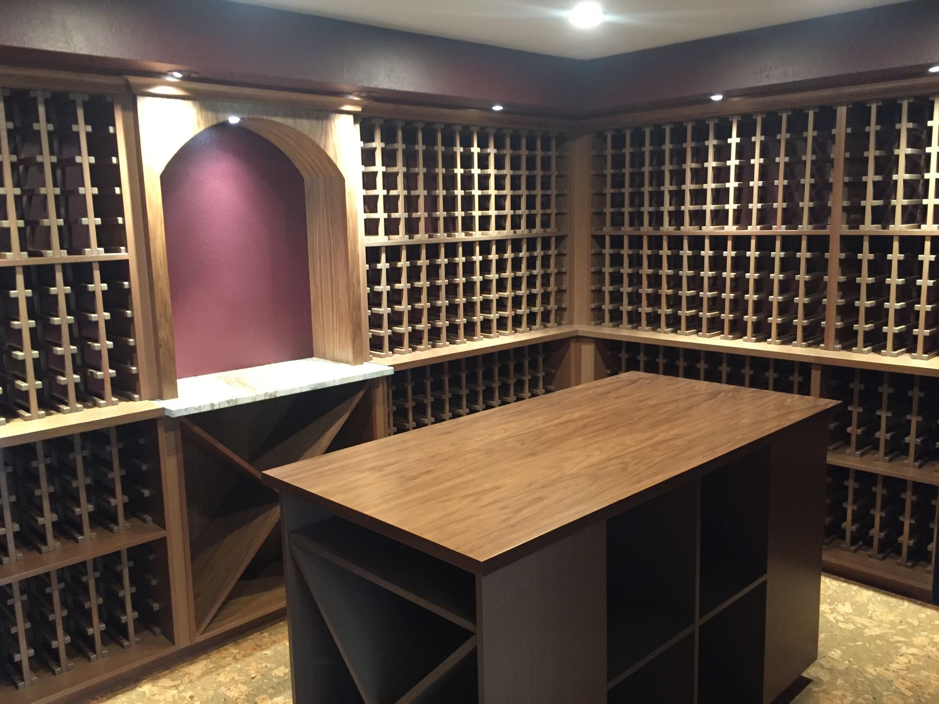 A wine cellar with a large wooden table in the middle