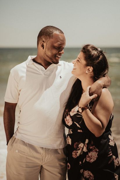 A young couple smiling happily at each other after participating in an intimacy workshop in Orlando, FL. This couples retreat is offered nationwide by Couples Workshops of Florida.