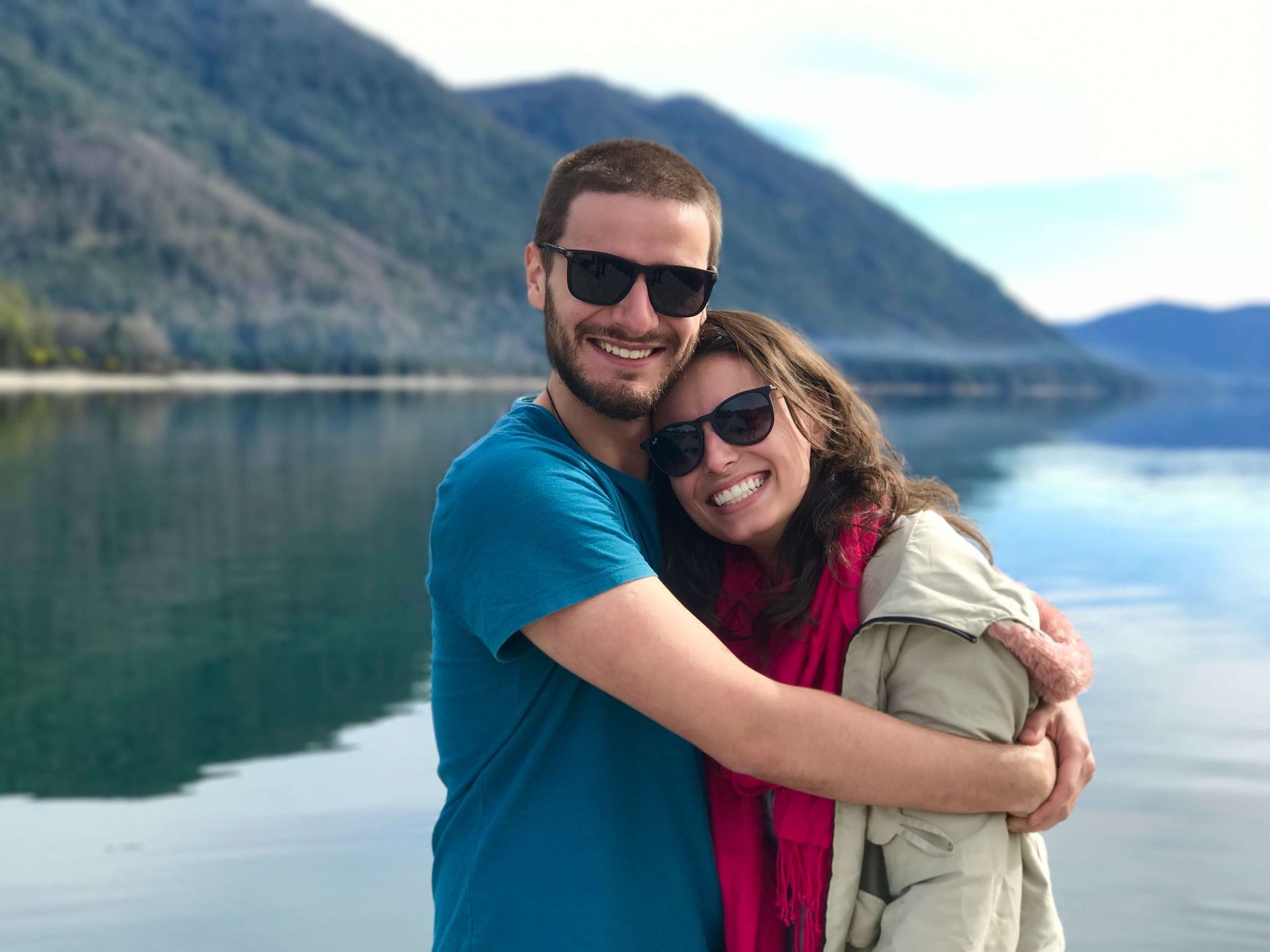 A couple stands in front of a lake smiling as they embrace. Rekindle your intimacy in a Couples Retreat in Orlando, FL today. Our couples retreats are here for anyone in the United States and beyond.