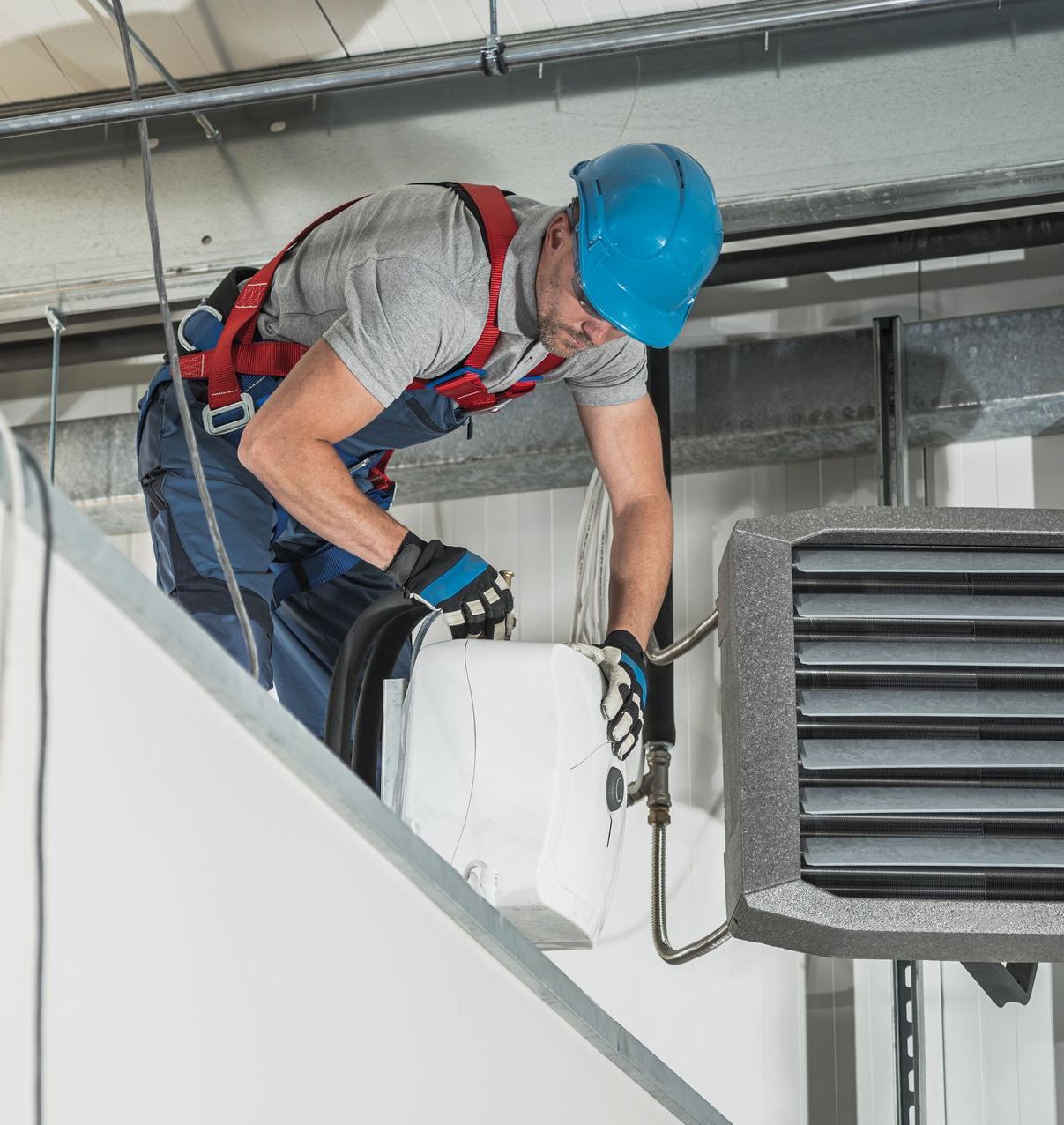 HVAC technician installing new warehouse air