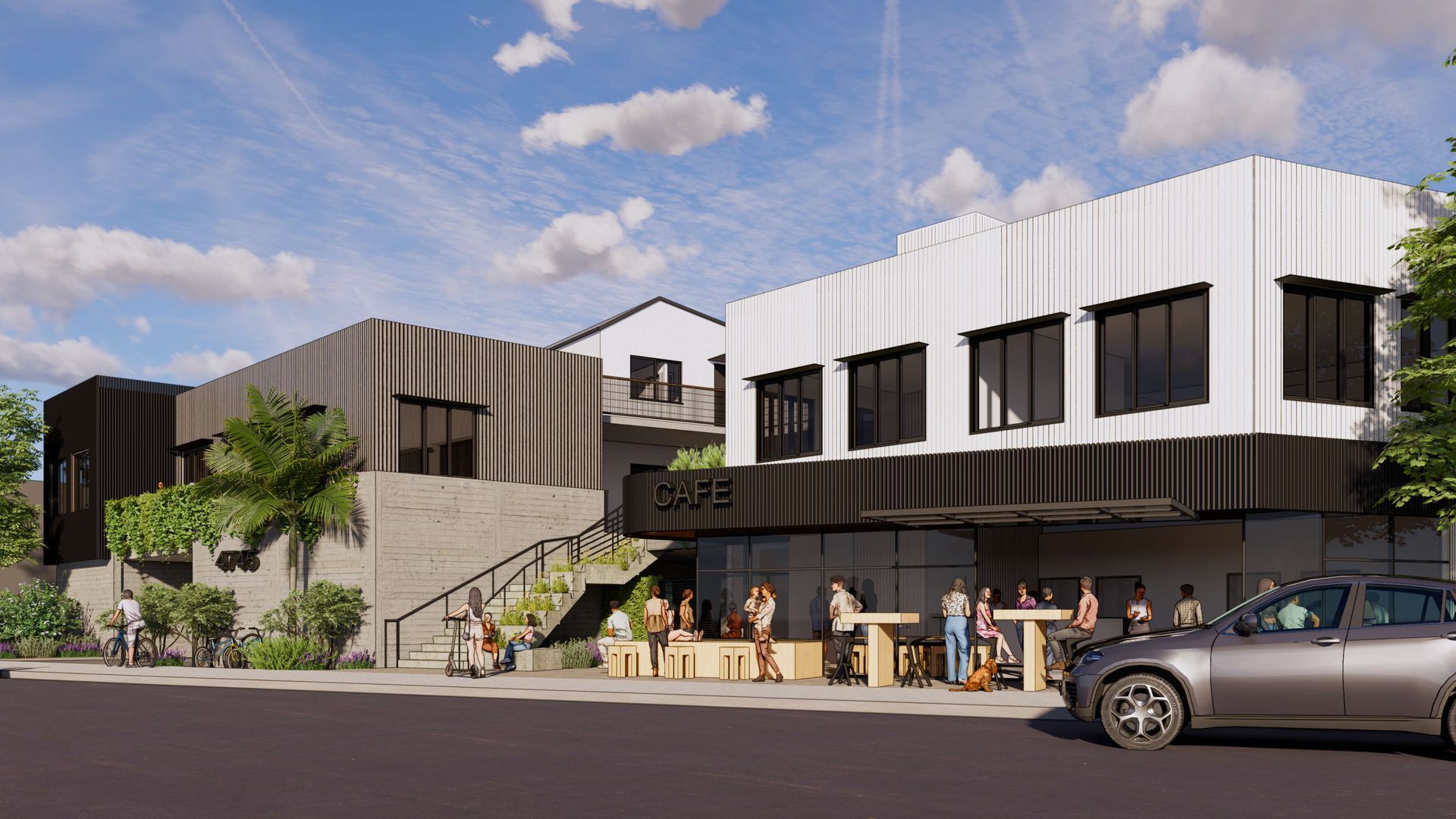 Modern commercial building with outdoor seating and pedestrians.