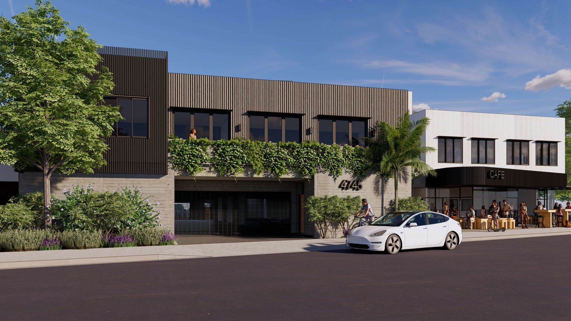 Modern building with storefront, green plants, and a white car parked in front.