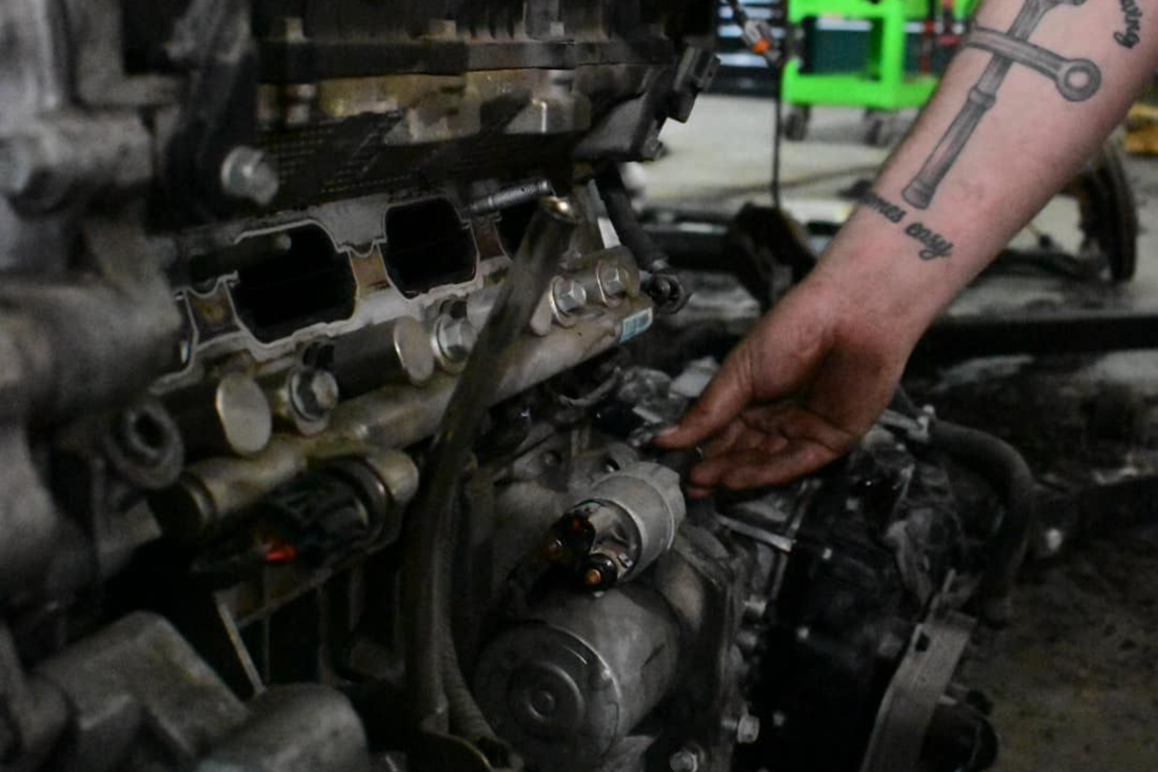 A group of trucks are parked in a field in front of a building.