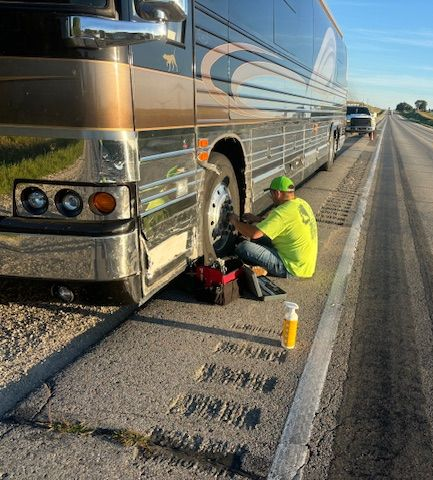 A man in a black shirt is working on a car