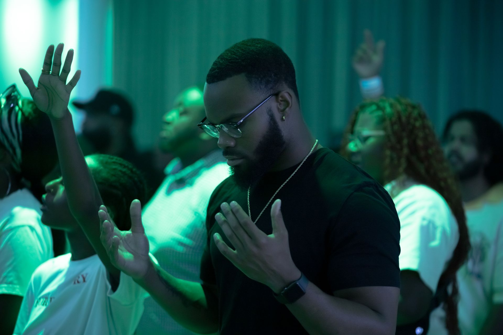Two smiling women holding a sign reading