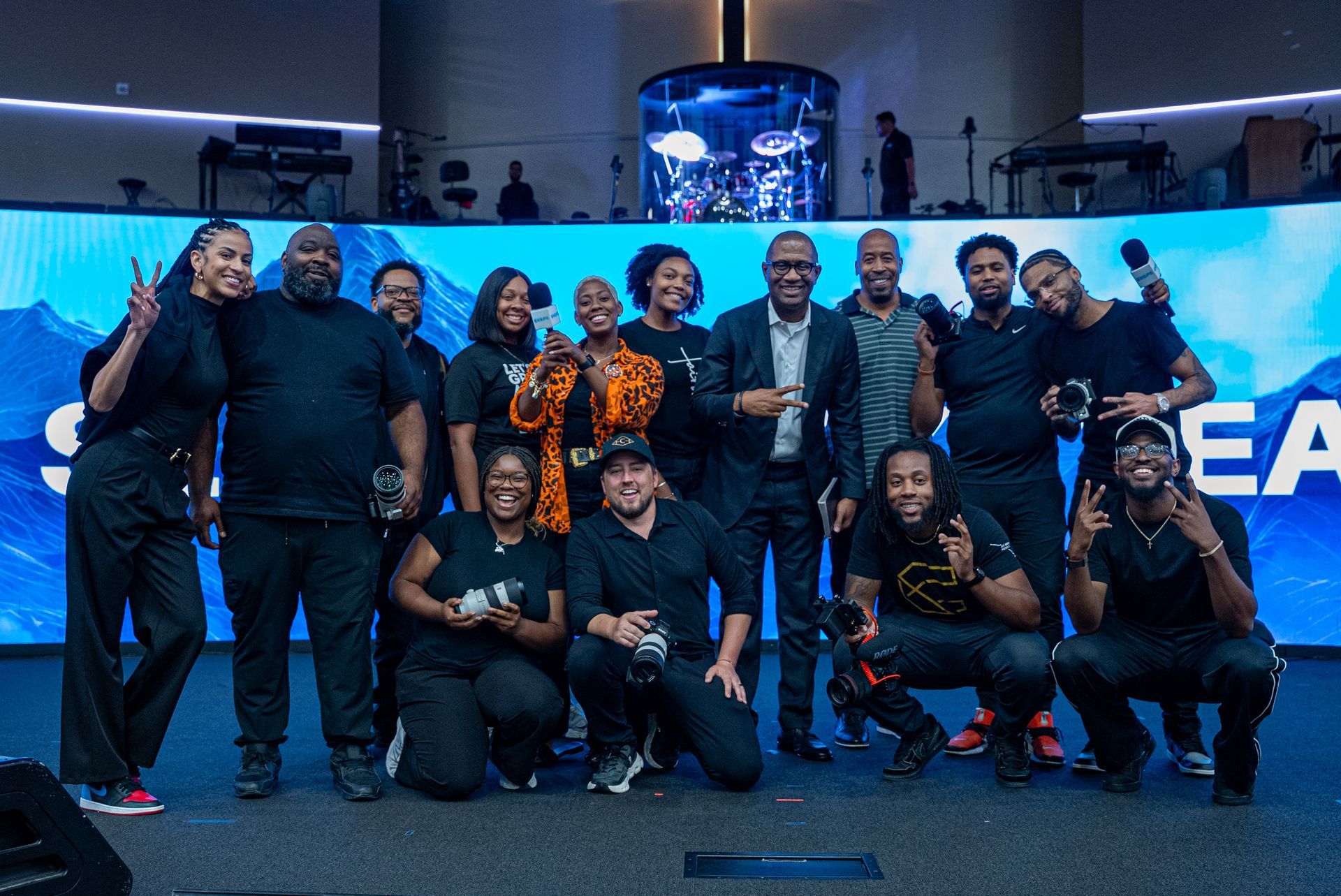 Woman in headset, face mask, looking focused.