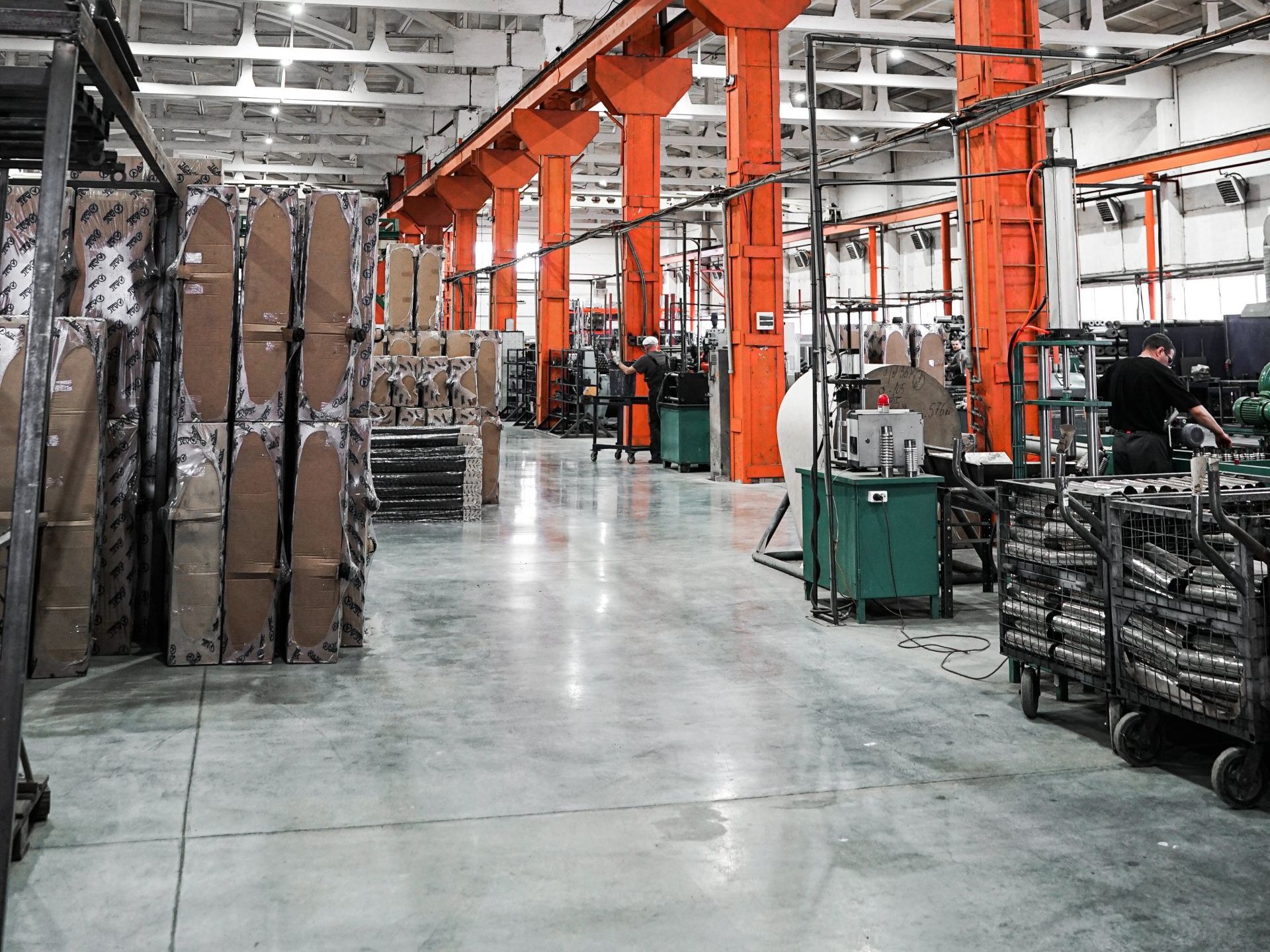 A large warehouse filled with lots of boxes and machinery.