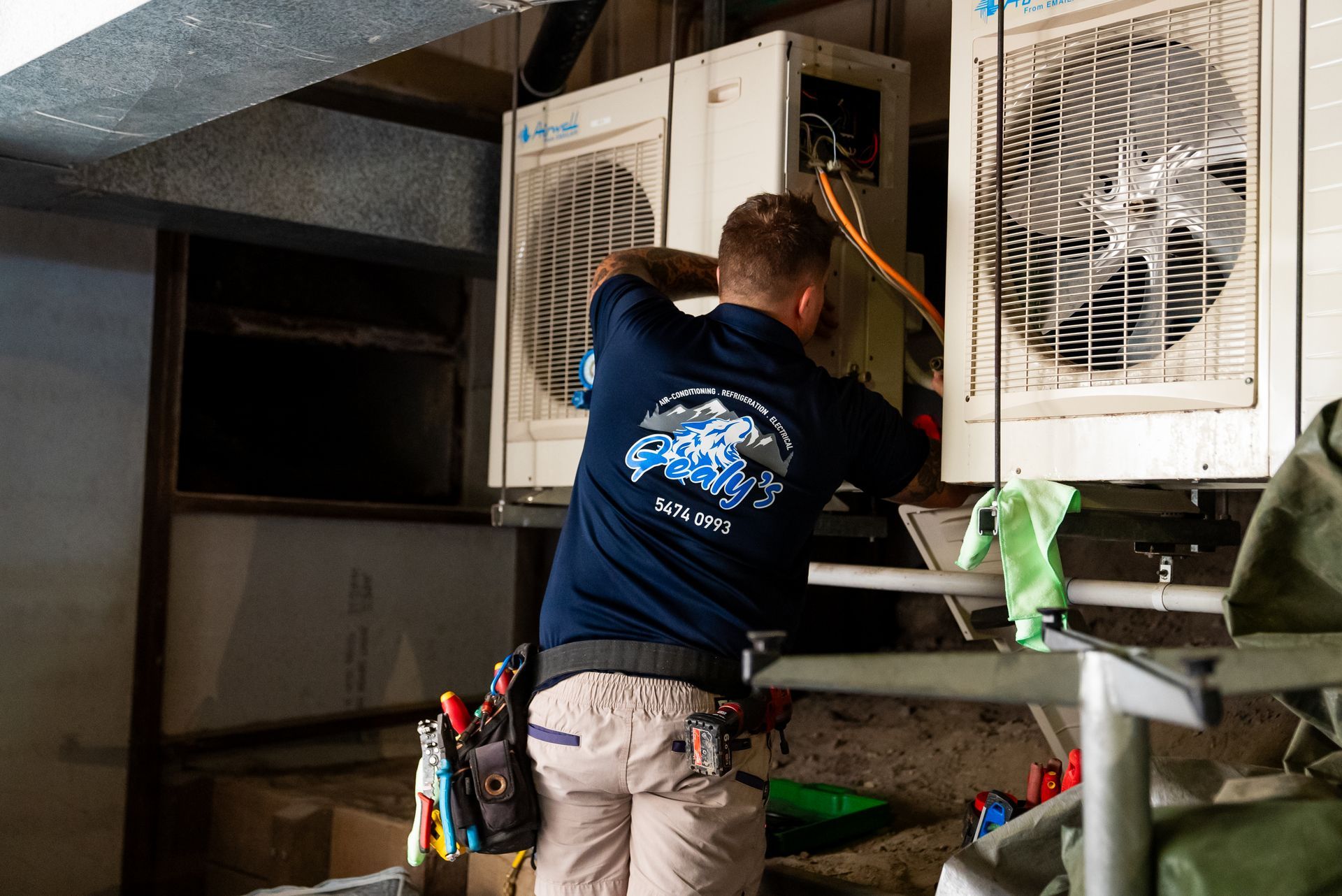 White oval bathtub in a modern bathroom with a large window overlooking greenery.
