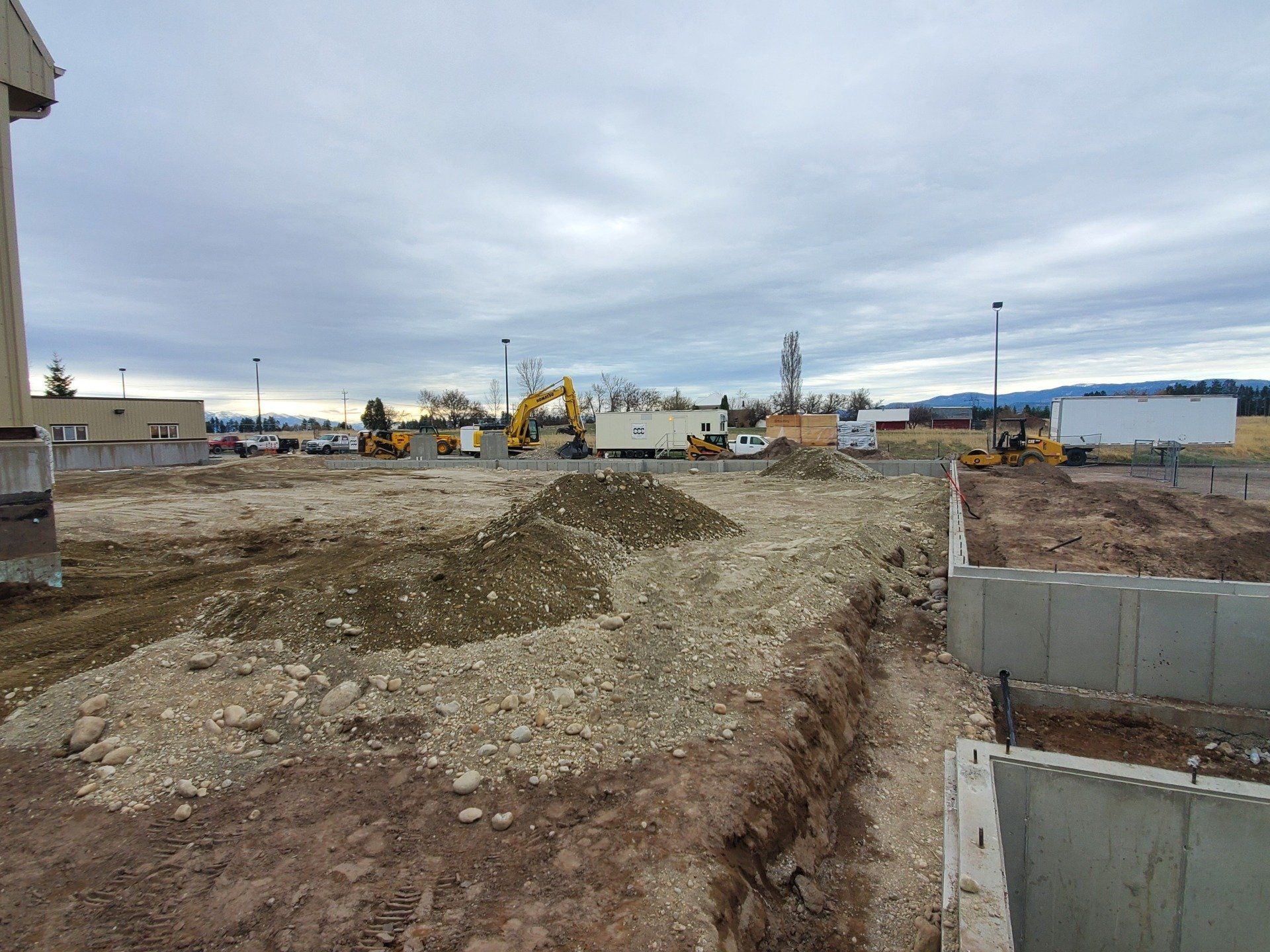 A construction site with a pile of dirt in the middle