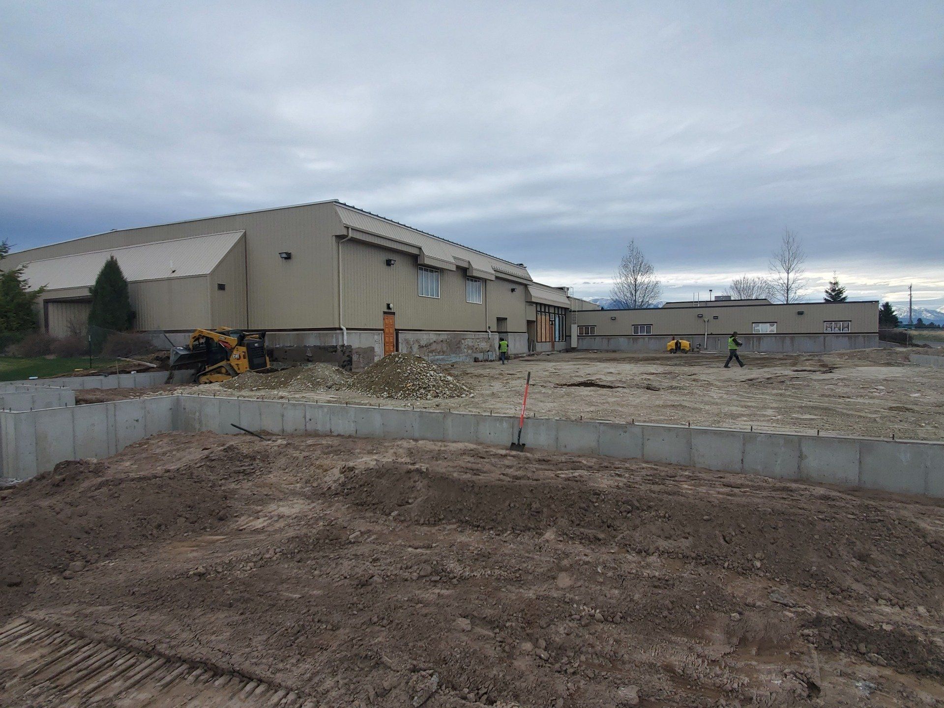A large building with a lot of dirt in front of it.