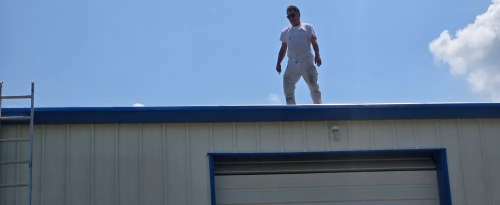 A man is standing on the roof of a building.
