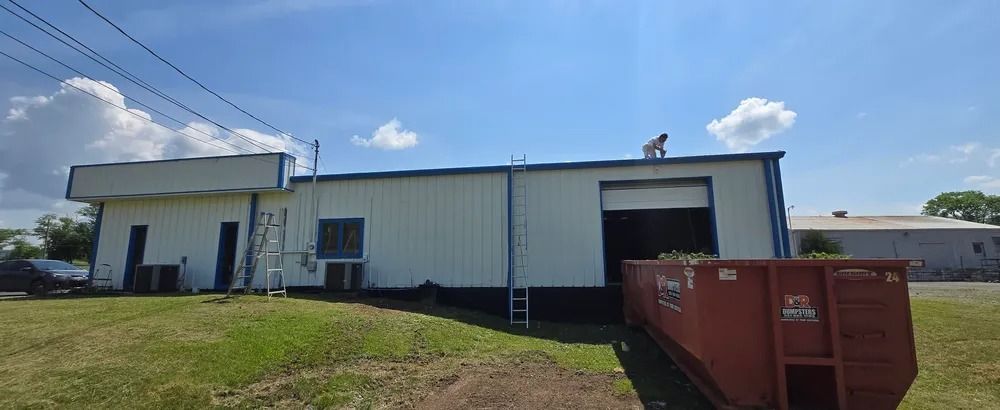 A man is standing on the roof of a building.