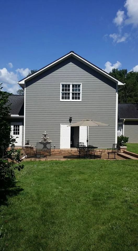 A large house with a large lawn in front of it.
