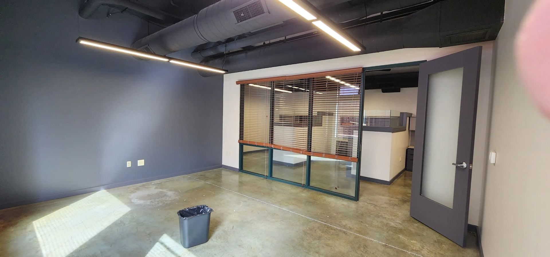 There is a trash can in the middle of the room.