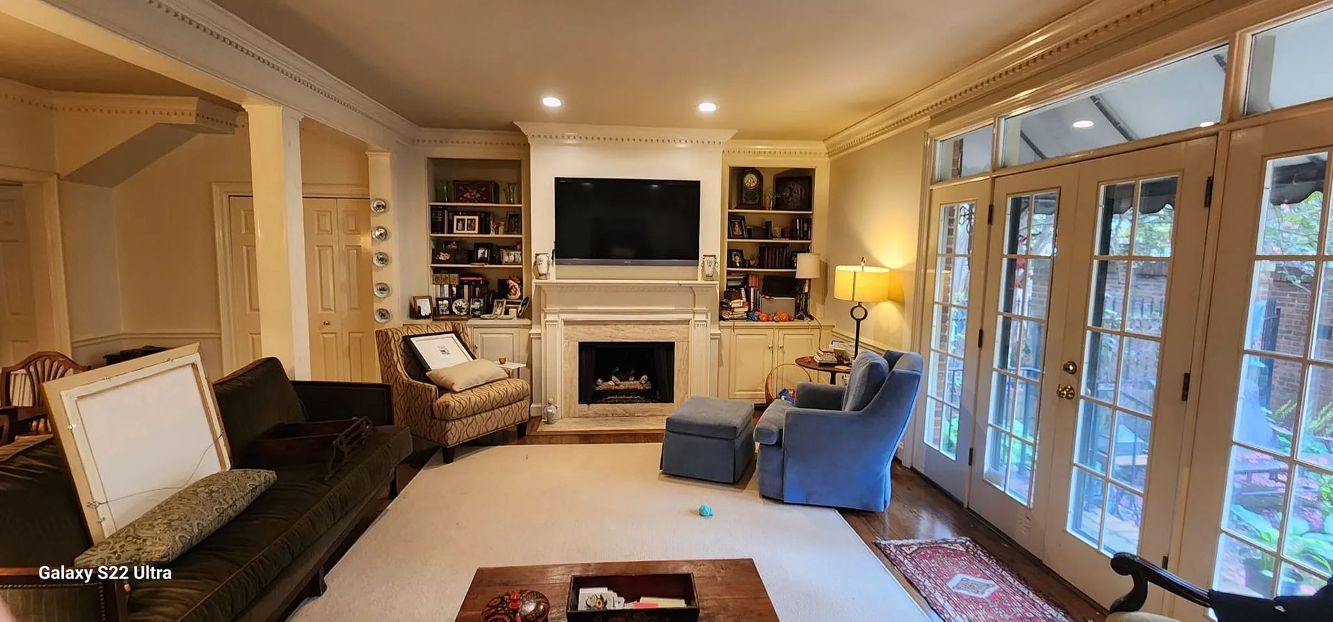 A living room filled with furniture and a fireplace.