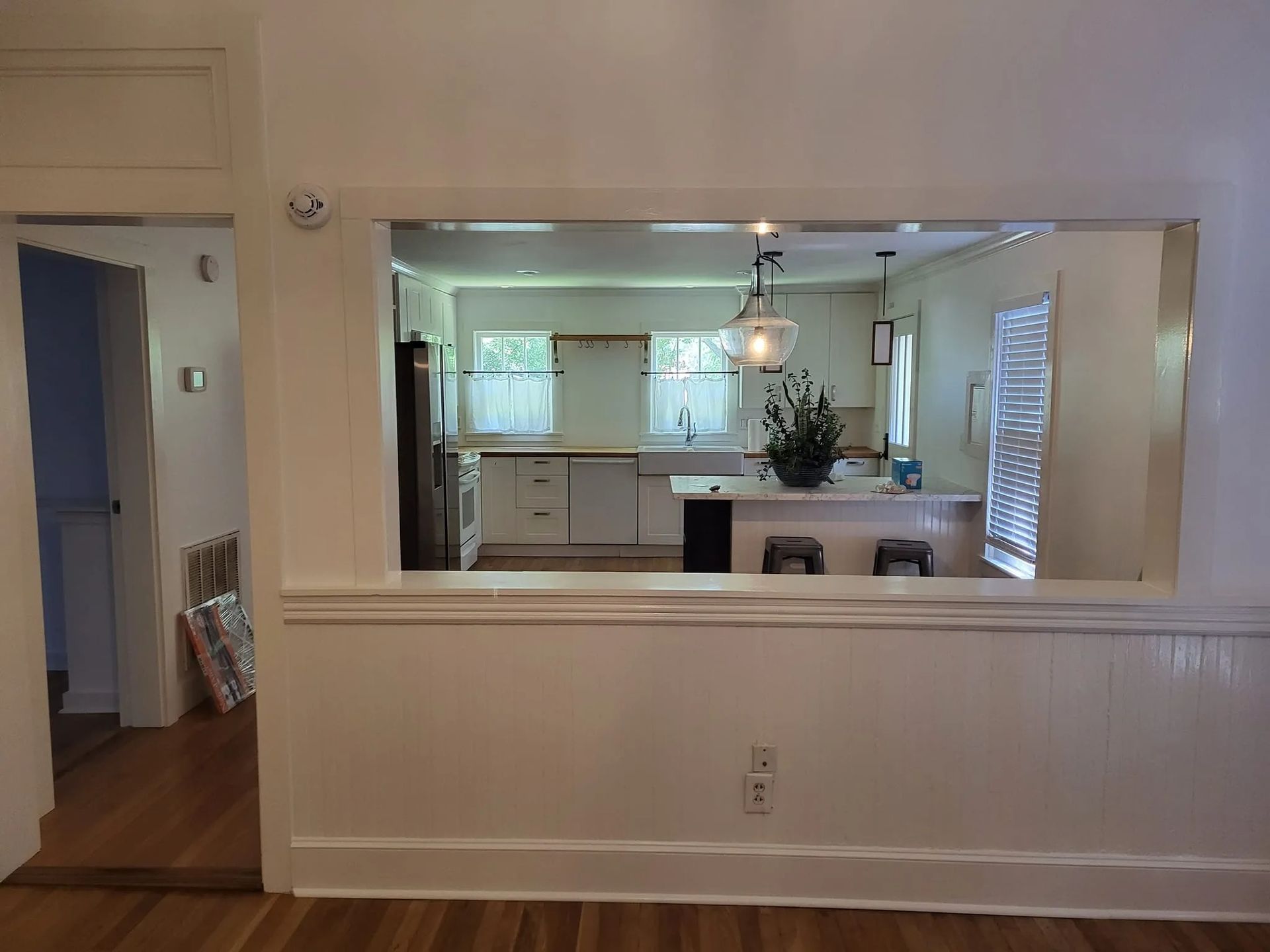 A view of a kitchen through a window in a house.