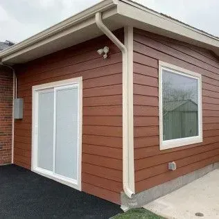 Empty room with beige walls, white trim, and a closed white door.