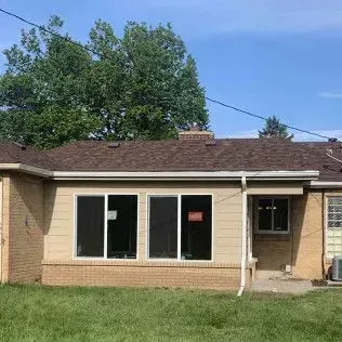 Black corner pool cue rack holding several cues.