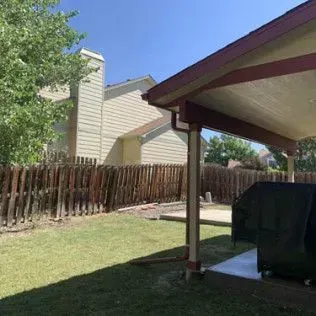 Hallway with wood floors, a door to a bathroom, and a closed door on the left.
