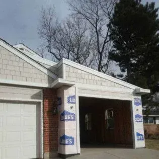 Pool table in a dimly lit basement with a TV and fireplace in the background.