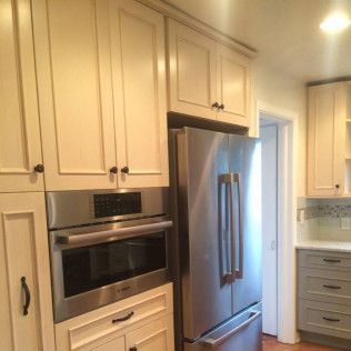 Kitchen with light cabinets, stainless steel appliances, and a gray cabinet base.
