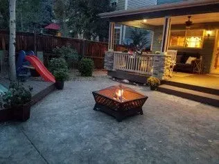 Empty room with tan walls, carpet, support beam, and ceiling lights.