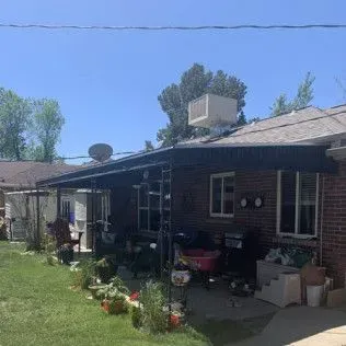 Basement recreation room with pool table, TV, blue bean bag chairs, and a doorway.
