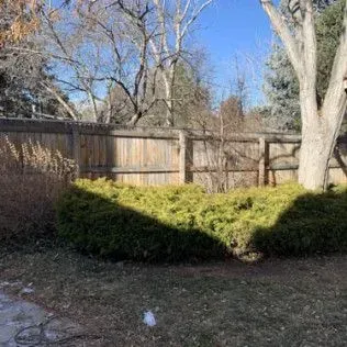 Interior room with a white door open to a dark space, another closed white door, and a window.