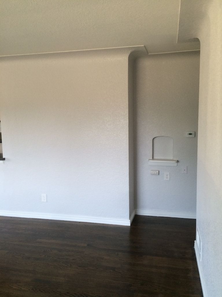 Interior view of room with gray walls, dark wood floor, and doorway to the right.