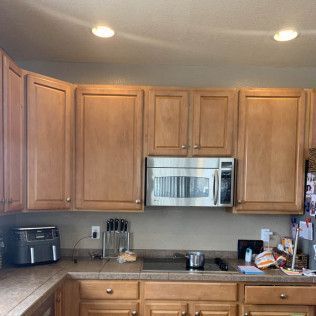 Kitchen cabinets with microwave, countertop, and appliances.