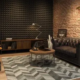 Living room with dark soundproofing wall, brick wall, leather sofa, rug, and wooden coffee table.