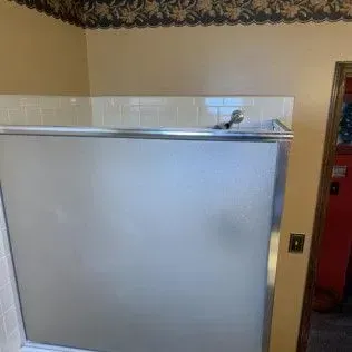 Frosted glass shower door in a bathroom.