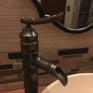 Bronze bamboo-style bathroom faucet with a dark finish.