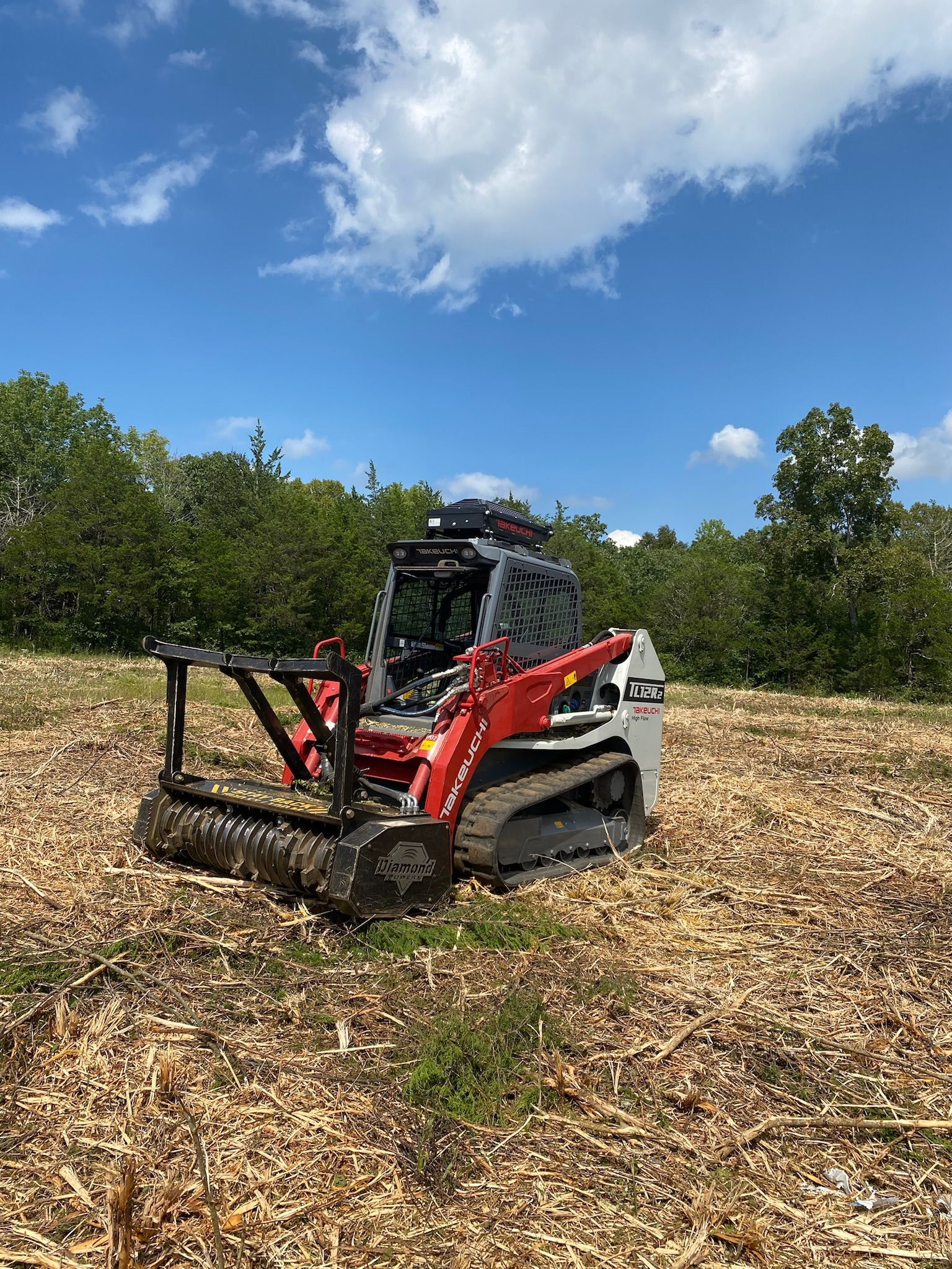 A bulldozer is sitting in the middle of a field.